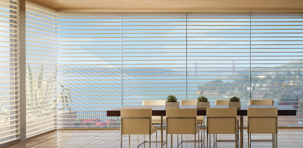 Large dining room with long dining room table in front of large picture windows with Silhouette Original blinds.